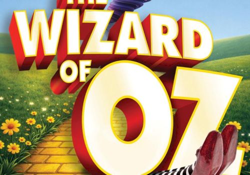 A colorful &ldquo;Wizard of Oz&rdquo; poster shows a yellow brick road, green hills and flowers, plus ruby red slippers at the bottom.