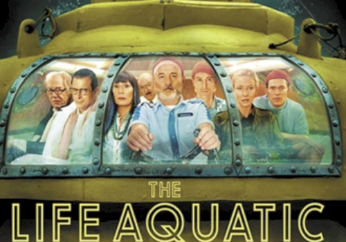A group of people is seated inside a submarine cockpit labeled "The Life Aquatic" with a yellow background.