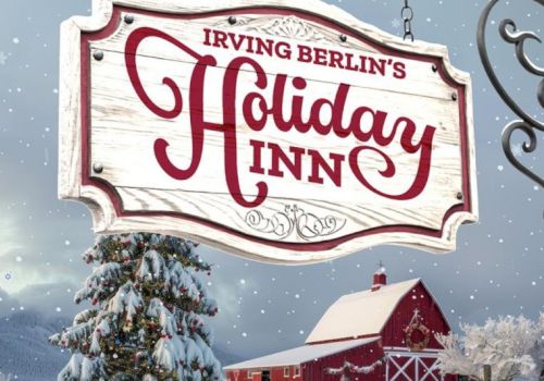 A snowy scene with a festive sign reading "Irving Berlin's Holiday Inn" in front of a snow-covered barn and decorated Christmas tree.