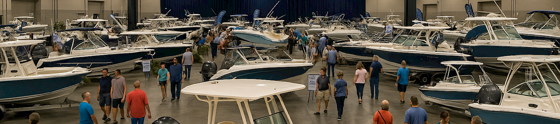 The image shows a boat show at the Ocean Center, with various boats on display and people walking around.