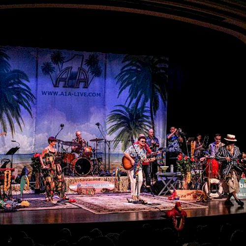 A band performs on stage with tropical decor, palm trees, and various instruments, creating a lively atmosphere.
