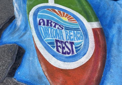 A close-up of colorful street graffiti showing a circular emblem with Italian-style text on a blue-red-green background.