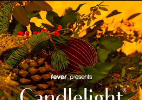 The image features holiday-themed decorations with pinecones, leaves, and berries, and text "fever presents Candlelight."