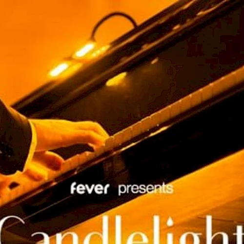 A pianist&rsquo;s hands glide over a piano keyboard under warm candlelight, with the text &ldquo;fever presents Candlelight&rdquo; on the cover.