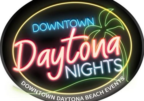 A neon-lit Daytona Nights sign promoting downtown Daytona Beach events.